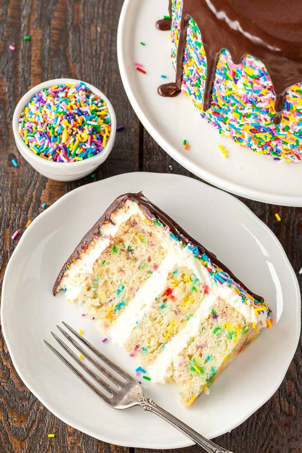 his Sprinkle Studded Funfetti Cake is paired with a fluffy cream cheese frosting and topped with a rich dark chocolate ganache.