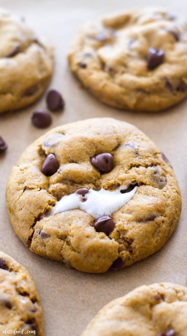These thick and chewy Pumpkin Chocolate Chip Cookies are baked with a gooey marshmallow inside, making these rich, chocolatey pumpkin cookies the perfect fall dessert!