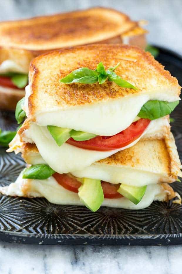 Caprese Sandwich Recipe is the classic combination of tomatoes, mozzarella and basil with the welcome addition of avocado slices, all sandwiched together between slices of buttery toasted bread.