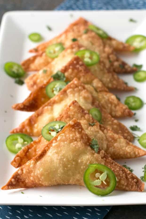 Jalapeño Avocado Cream Cheese Wontons are essentially a fried, amped up version of your favorite jalapeno cream cheese poppers appetizer! The creamy and spicy filling wrapped in a fried wonton wrapper makes these poppers a fantastic party appetizer or even an afternoon snack.