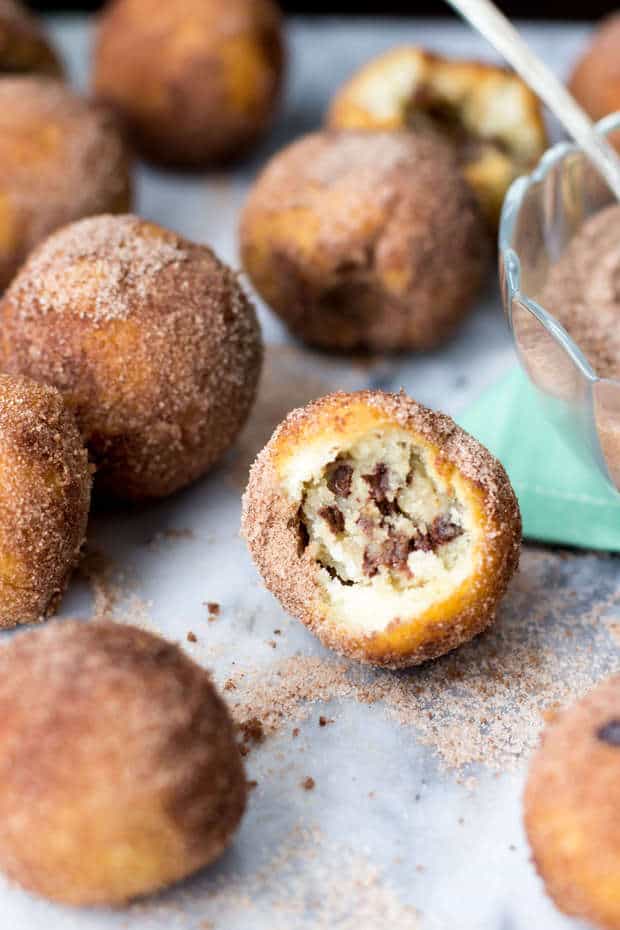 Say hello to your new favorite breakfast companion: cookie dough stuffed donut holes!  No-yeast-required, crammed full of cookie dough, and rolled in sea-salted chocolate sugar… you’re probably going to want to make a second batch.