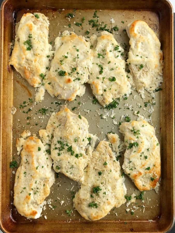 Baked parmesan chicken is a family favorite dinner that cooks up in a sheet pan with only a few ingredients. Chicken breasts are sprinkled with seasoned salt and pepper, and then covered in a creamy mixture with garlic and parmesan cheese.