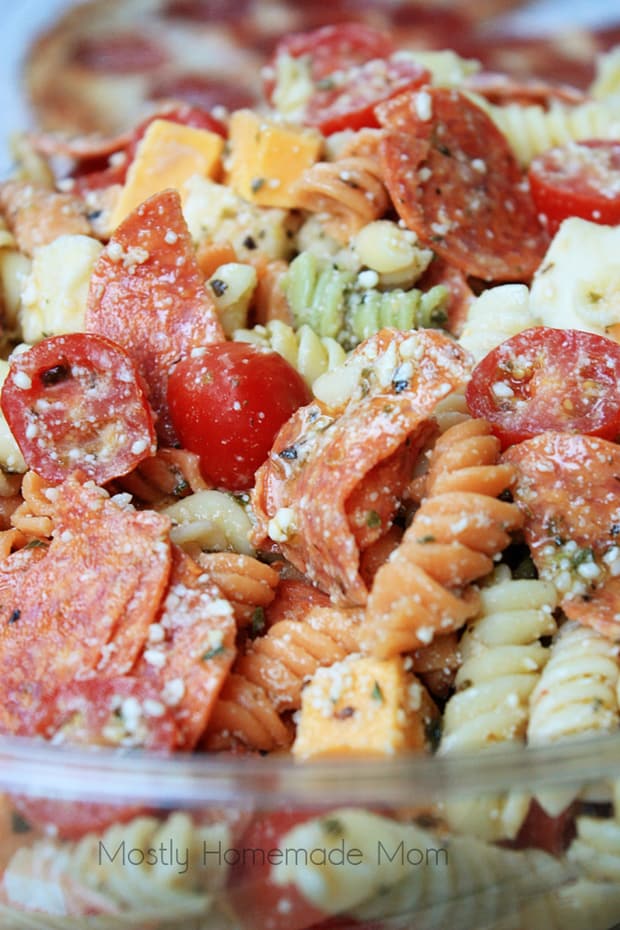  This Pepperoni Pizza Pasta Salad features tri colored rotini pasta with pepperoni, mozzarella, cheddar, and tomatoes in a Parmesan vinaigrette. This Italian pasta salad variation is the perfect summer side dish recipe!