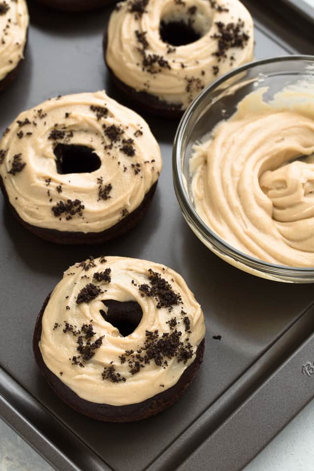 These Baked Chocolate Donuts with Peanut Butter Frosting will take you back to your childhood when things were simpler. They are a reminder of just how tasty breakfast can be. This chocolate donut recipe will give you the best baked donuts you’ve ever had. The recipe walks you through how to make donuts from scratch that are perfectly soft, chocolaty, and not overly sweet. These donuts are great for breakfast, brunch or snack any time of day!