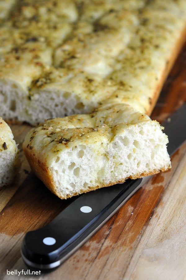 This easy no-knead Focaccia recipe is simple enough for the novice bread baker. Added pesto gives this classic a delicious twist!