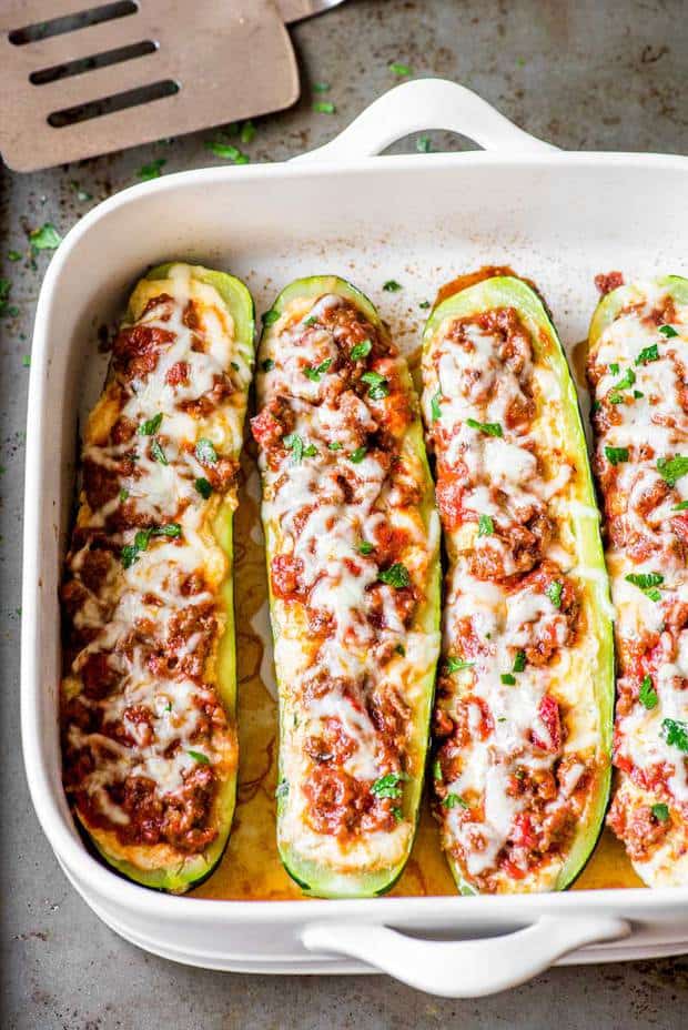 Tender baked zucchini filled with a mix of flavorful cheeses and topped with a meaty Ragu sauce. Plus, it's easy to adjust the serving amount of this recipe to fit any time, date, or occasion!