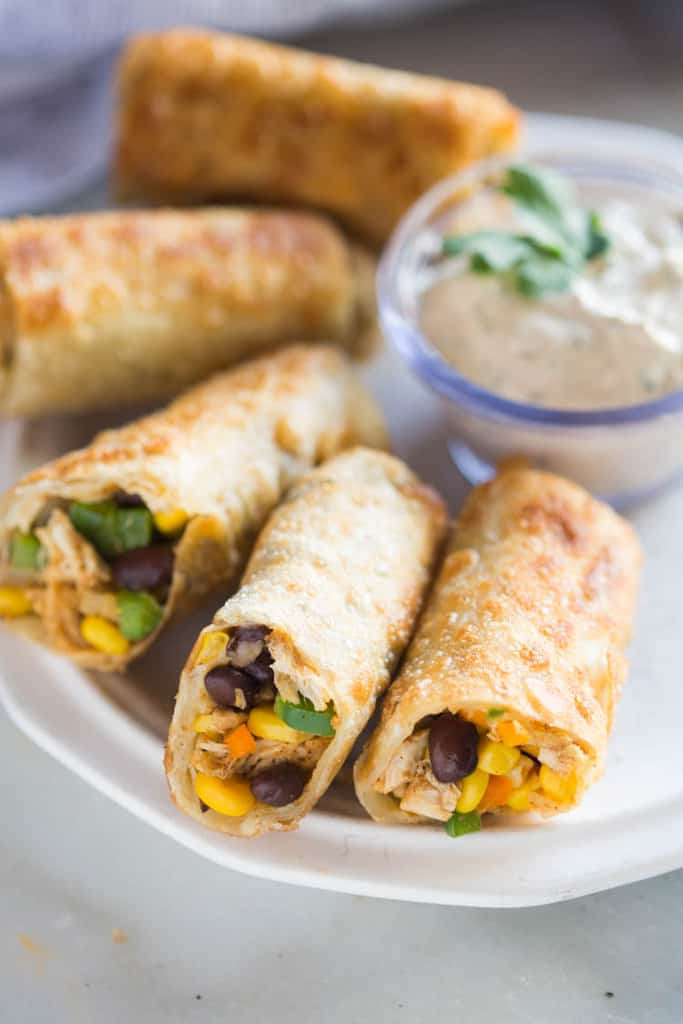 Crispy Southwest Egg Rolls (that you can bake or fry!) served with a creamy cilantro dipping sauce. These could be my favorite party appetizer of all time, (and they’re freezer friendly)!