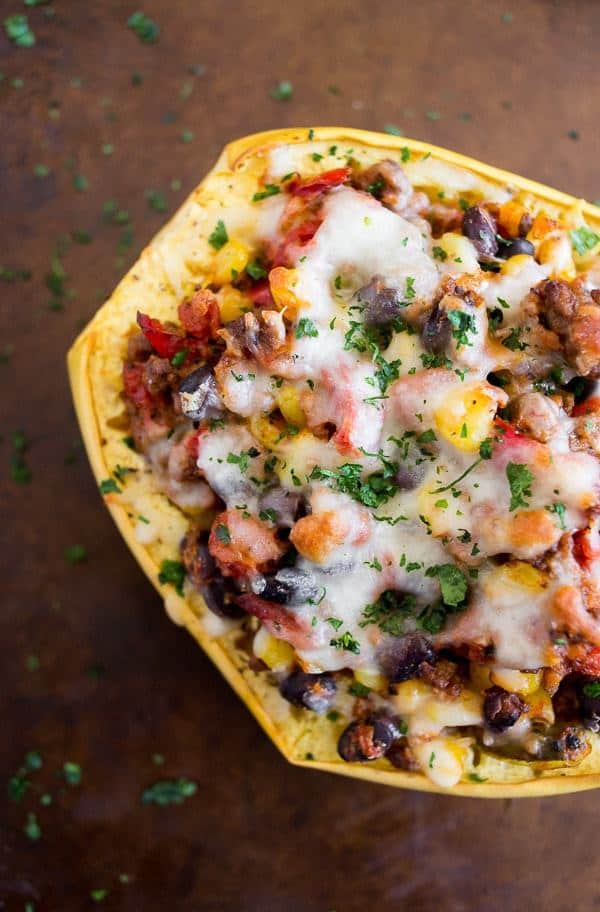 Southwest taco stuffed spaghetti squash is packed full of ground beef, vegetables, delicious spices and herbs and topped with spicy pepper jack cheese. Super simple to make and a total crowd pleaser. This dish is 100% comfort food!
