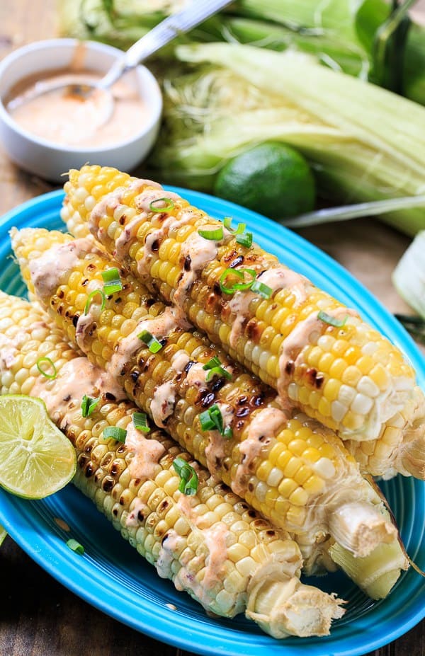 Grilled Corn charred to perfection and flavored with a creamy, smoky, and spicy chipotle sauce. Grilled Corn with Chipotle Cream is one of the most delicious ways to eat summer corn.