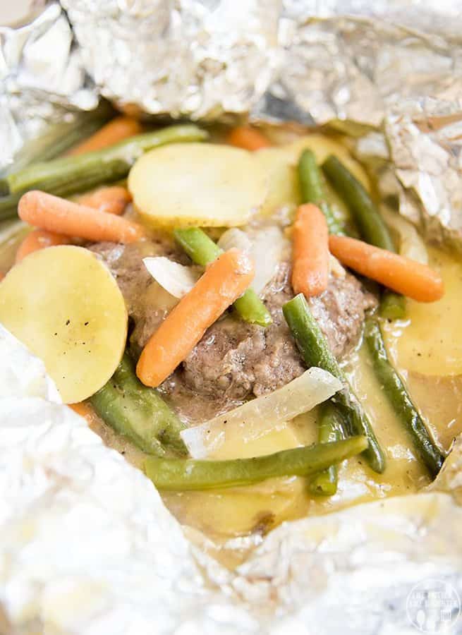 THESE HOBO DINNERS ARE A DELICIOUS AND EASY DINNER COOKED UP IN FOIL. GREAT COOKED OVER A CAMPFIRE, OR IN YOUR OVEN AT HOME. PACKED FULL OF FLAVOR AND CUSTOMIZABLE SO EVERYONE WILL LOVE THEM!