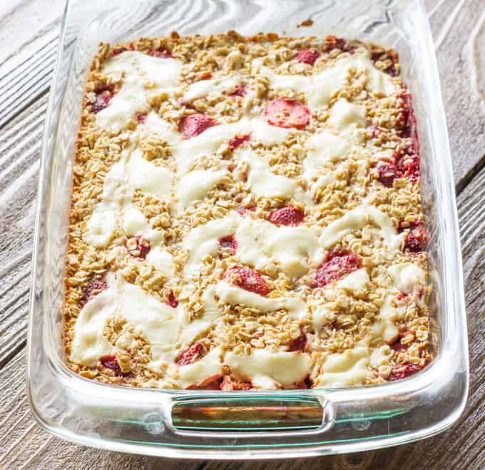 This recipe for strawberry cheesecake baked oatmeal has flavorful baked oats and a cheesecake swirl, which kind of tastes like cheesecake for breakfast!