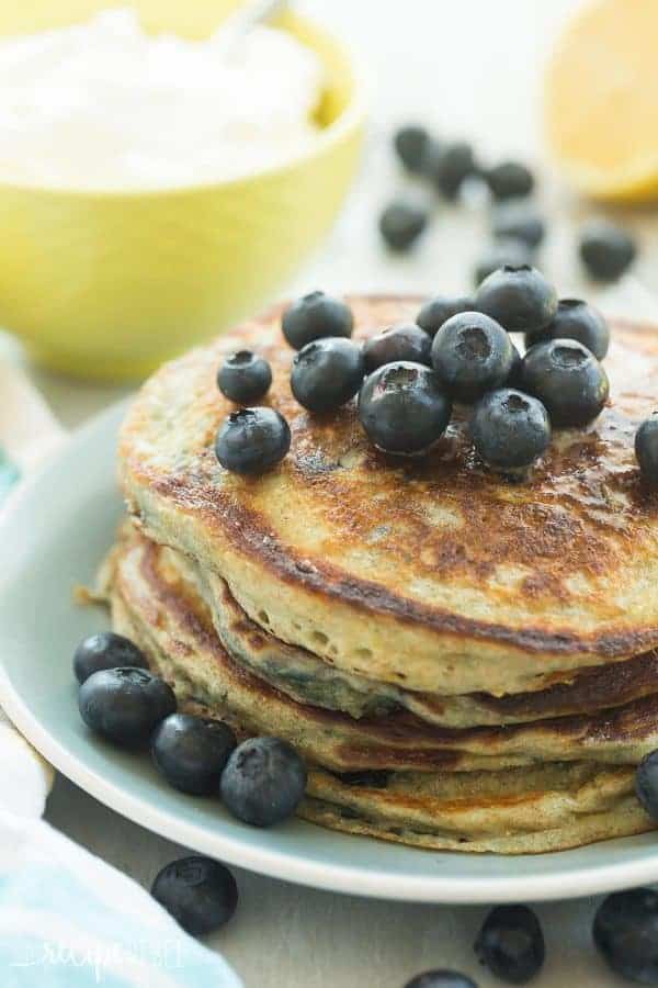 These Lemon Blueberry Greek Yogurt Pancakes are light, fluffy and made healthier with whole wheat flour! They’re loaded with blueberries and pack a punch of citrus flavor!