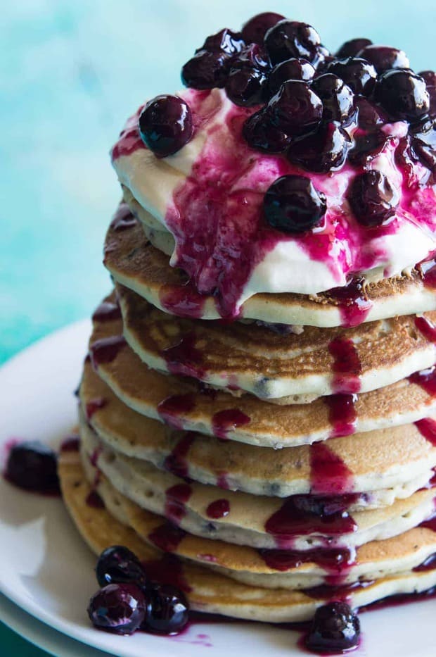 Blueberry Cheesecake Pancakes!  Soft pancakes bursting with juicy blueberries.  Topped with a fluffy cheesecake topping and a homemade blueberry sauce.  You will want to start everyday with this breakfast!  Life just doesn’t get any better.