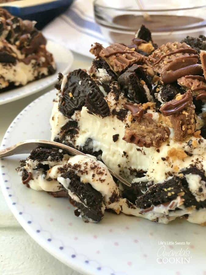 Peanut Butter Oreo No Bake Cheesecake combines cheesecake with Oreo cookies and Reese’s Peanut Butter Cups to create a decadent dessert!  Bring this rich and creamy, no bake, one pan layered dessert to your next gathering for everyone to enjoy.