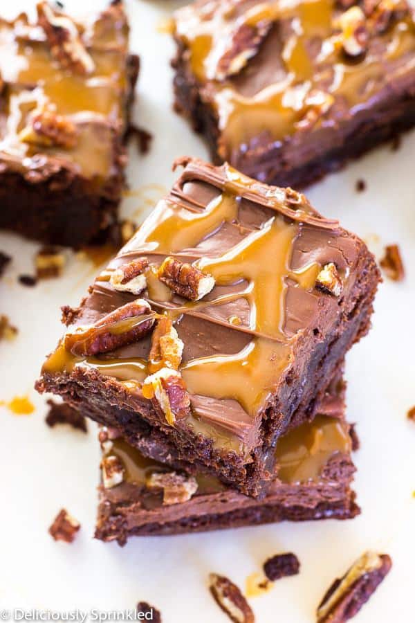 Frosted Turtle Brownies are thick and fudgy topped with milk chocolate frosting, caramel sauce and chopped pecans.