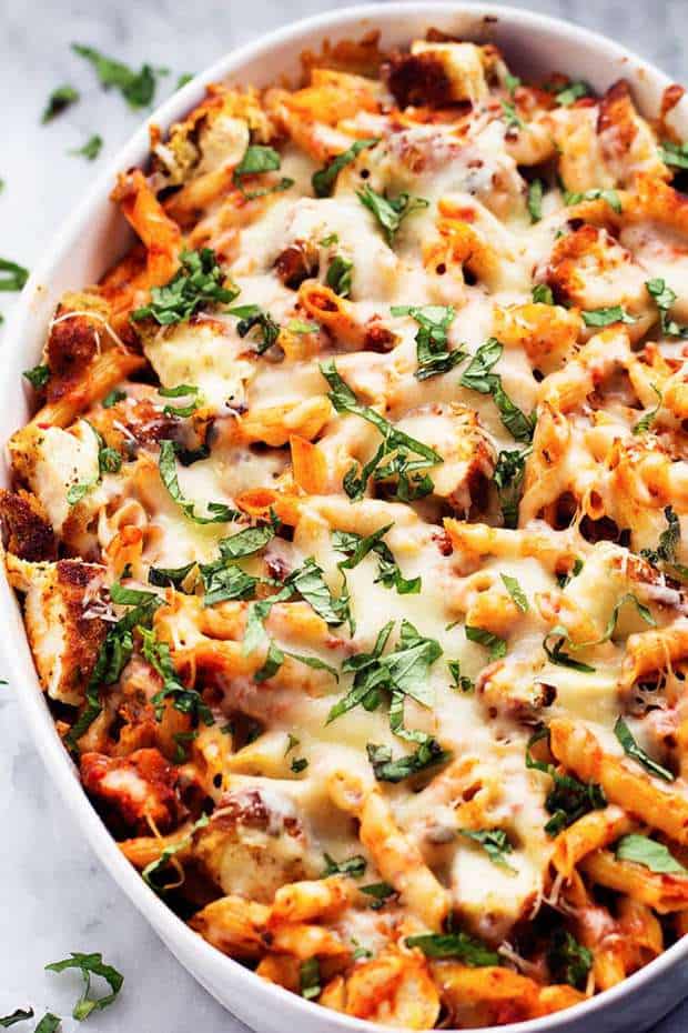 All of the goodness of chicken parmesan packed into a delicious cheesy casserole!  Crispy chicken, marinara sauce, penne pasta, and cheese come together in this easy to make dish!