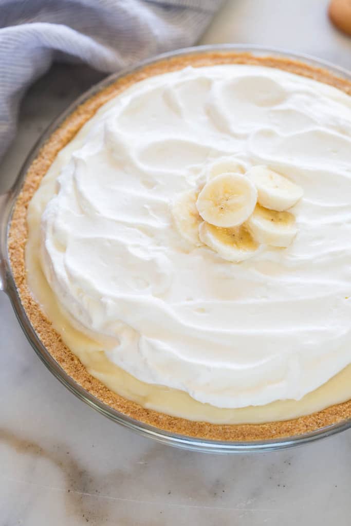 Homemade Banana Cream Pie with no box-pudding mix. A delicious homemade custard filling that holds together perfectly, layered inside a nilla wafer crust.