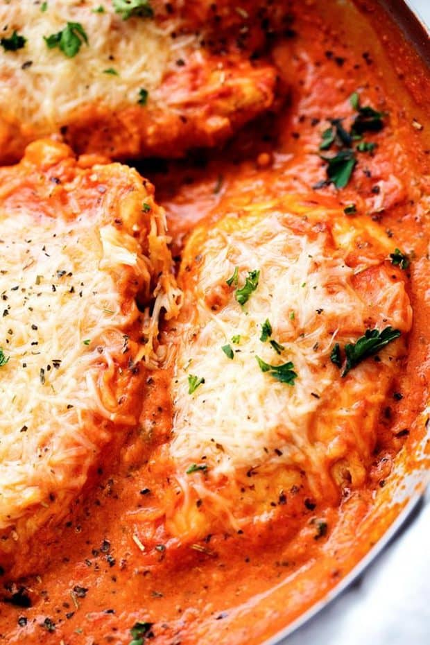 Creamy Tomato Italian Parmesan Chicken is a creamy red tomato parmesan sauce with delicious Italian spices.  The chicken gets smothered in melty parmesan cheese and will be one of the most delicious meals you eat!