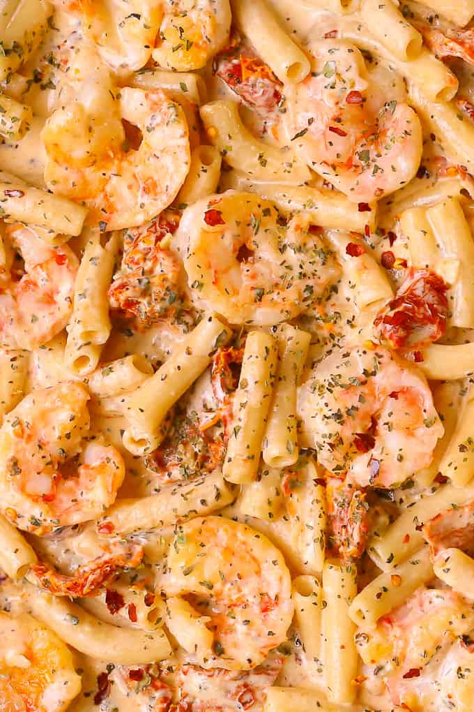 This shrimp pasta features creamy Mozzarella sauce, sun-dried tomatoes, basil, and red pepper flakes.  Easy weeknight dinner!