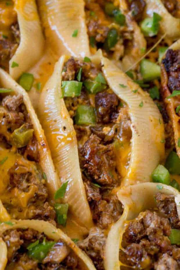 Philly Cheesesteak Stuffed Shells Made With Ground Beef, Cheddar, Bell Peppers And Onions With A Creamy Sauce To Drizzle Over The Shells When They’re Done.