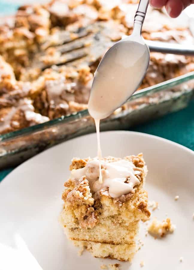 The best ever cinnamon roll cake that is perfect for breakfast with a cup of coffee, but also a great crowd pleasing dessert!  This cake is super soft and moist, has a gooey cinnamon brown sugar swirl, and is easy as can be to whip up in no time!