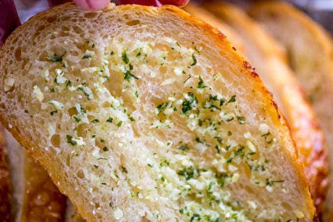 Sliced Garlic Bread Loaf made with a pre-sliced loaf of bread in just minutes and enough to feed a large crowd with no mess or slicing involved. In the oven in minutes.