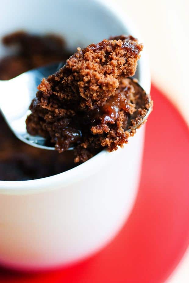 It takes just a few minutes to have this hot, gooey hot fudge mug cake in your hands and ready to scarf down. With a scoop of ice cream on top, you've got a pretty killer dessert that took no time at all!