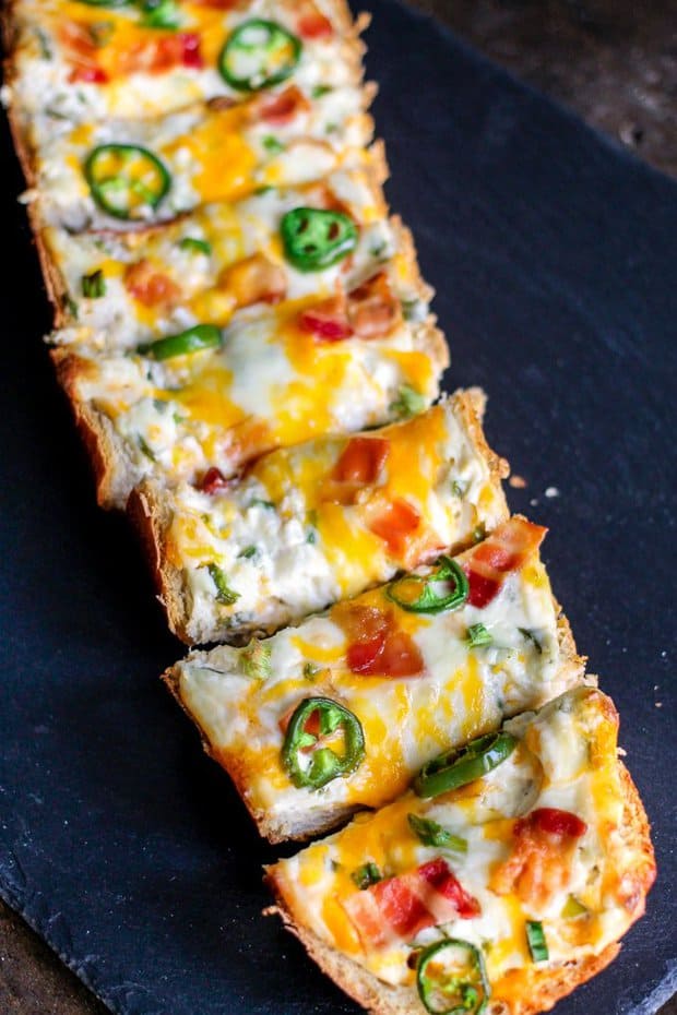 Jalapeno Popper Cheese Bread is the perfect blend of spice and creaminess topped with crunchy bacon. This appetizer will not last long at your next party!
