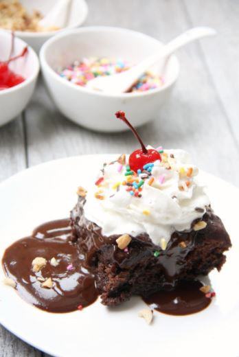 I’m so excited to share this delicious cake recipe! This is an easy cake to whip up and as long as you follow the directions it is nearly fool-proof. It is also pretty magical. When the cake is done baking in your slow cooker you serve up the cake and there is smooth and delicious hot fudge underneath to serve on top of the cake! Magic! Make the cake even better by adding your favorite sundae toppings on top or add a scoop of ice cream.