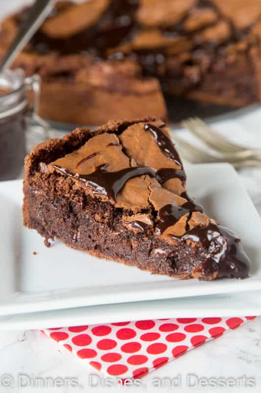 Gooey Brownie Pie – a gooey chocolate brownie with a crackly top baked into a pie and topped with hot fudge. A delicious and easy dessert for any chocolate lover.