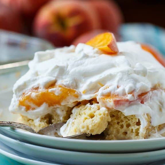 Peach Bourbon Tres Leches Cake makes a wonderful make ahead dessert for a summer get together. It is cool and creamy and fabulously rich with a layer of sliced fresh peaches and a little bourbon to add another flavor dimension.
