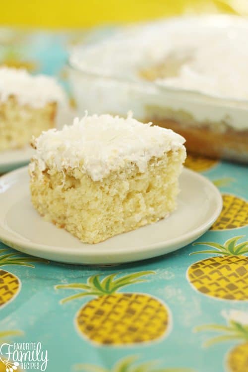 PPina Colada Poke Cake is bursting with coconut and pineapple. The topping on this cake is to die for! It is the perfect summer dessert!
