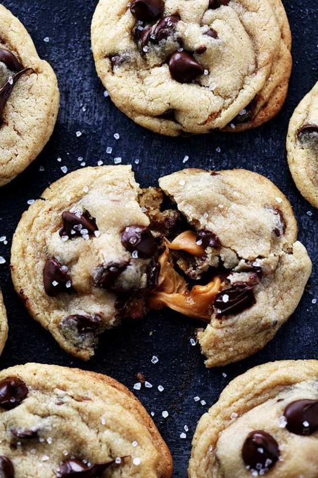 Salted Caramel Stuffed Chocolate Chip Cookies are the most perfect and soft chocolate chip cookies stuffed with ooey gooey caramel and topped with sea salt!  No chilling required!!