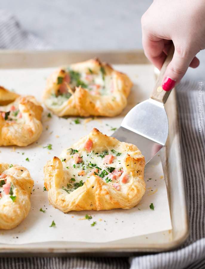 These ham and cheese spinach puffs are elegant, yet incredibly easy, and a perfect use for any leftover ham you may have!  I love the crispy, flaky puff pastry mixed with the creamy mixture filled with savory diced ham, nutty Gruyere cheese, and fresh spinach!