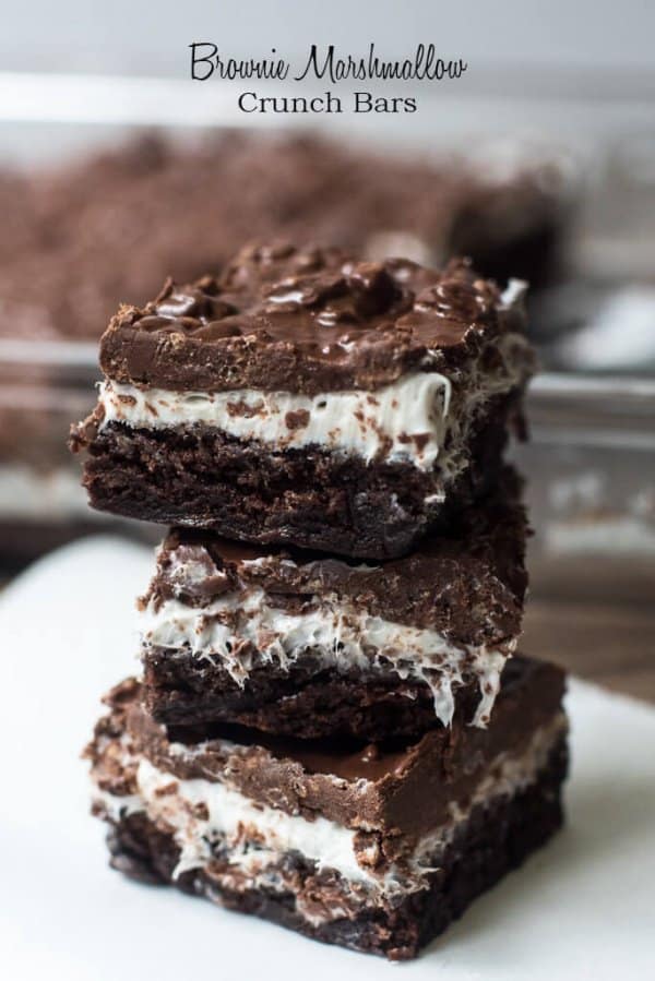 A fuggy brownie layer is topped with fluffy marshmallow frosting and a crunchy, chocolate and peanut butter topping. These layered Brownie Marshmallow Crunch Bars will knock your socks off!