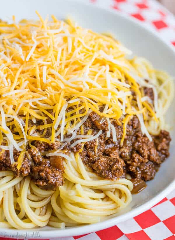 Deliciously hearty this Cincinnati Chili is a unique chili recipe served over spaghetti and topped with cheese, onions or beans or a combination of the 5!