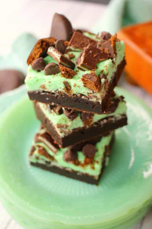 Let me introduce you to your new favorite brownie recipe!  A perfect combination of chocolate and mint, these fudgy mint brownies are topped with Girl Scout Thin Mint Cookies, Andes mints, chocolate chips, and an amazing layer of mint butter cream frosting.  Most definitely a brownie lover’s dream come true!