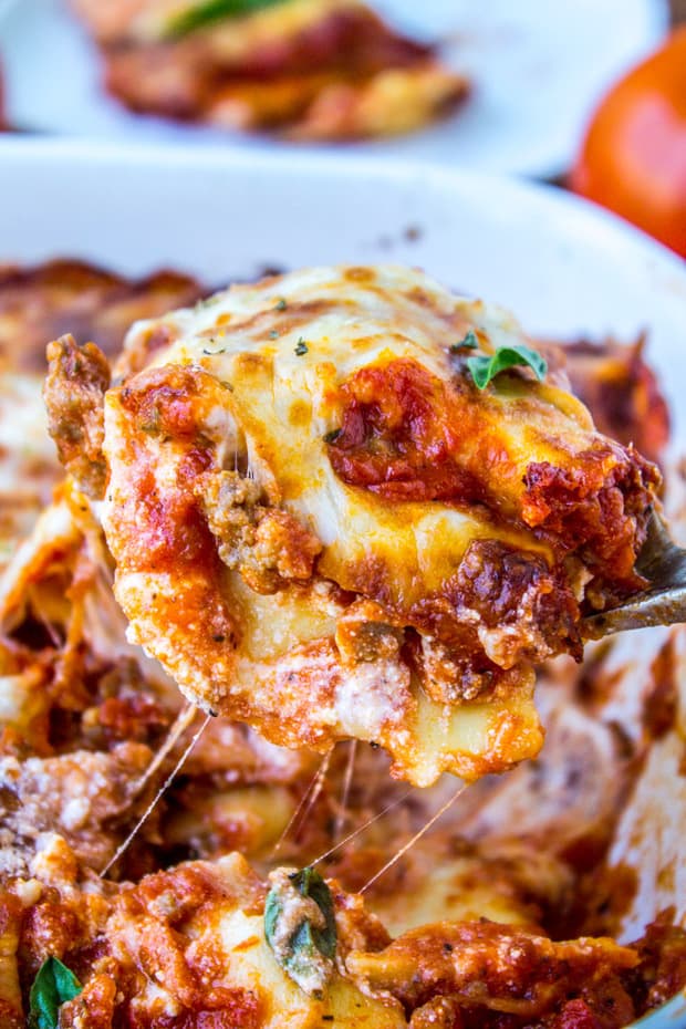 Easy Cheesy Ravioli Lasagna is a hearty no-brainer dinner to make on busy back-to-school nights. You don’t even have to cook the ravioli, just throw it in frozen. It’s a total crowd-pleaser! And a great make-ahead meal too.