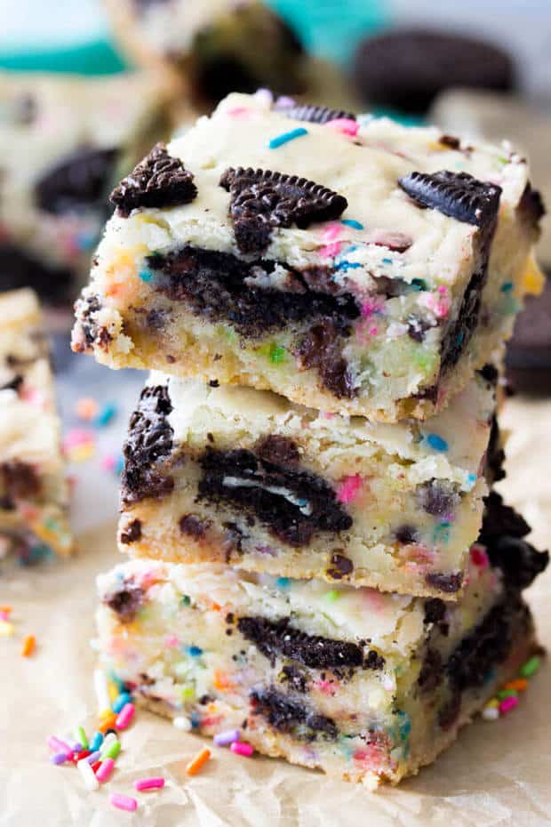 Soft, chewy, Funfetti Oreo Bars!  These buttery cake batter flavored bars are jam-packed with mini chocolate chips, colorful sprinkles, and a center layer of Oreo cookies.