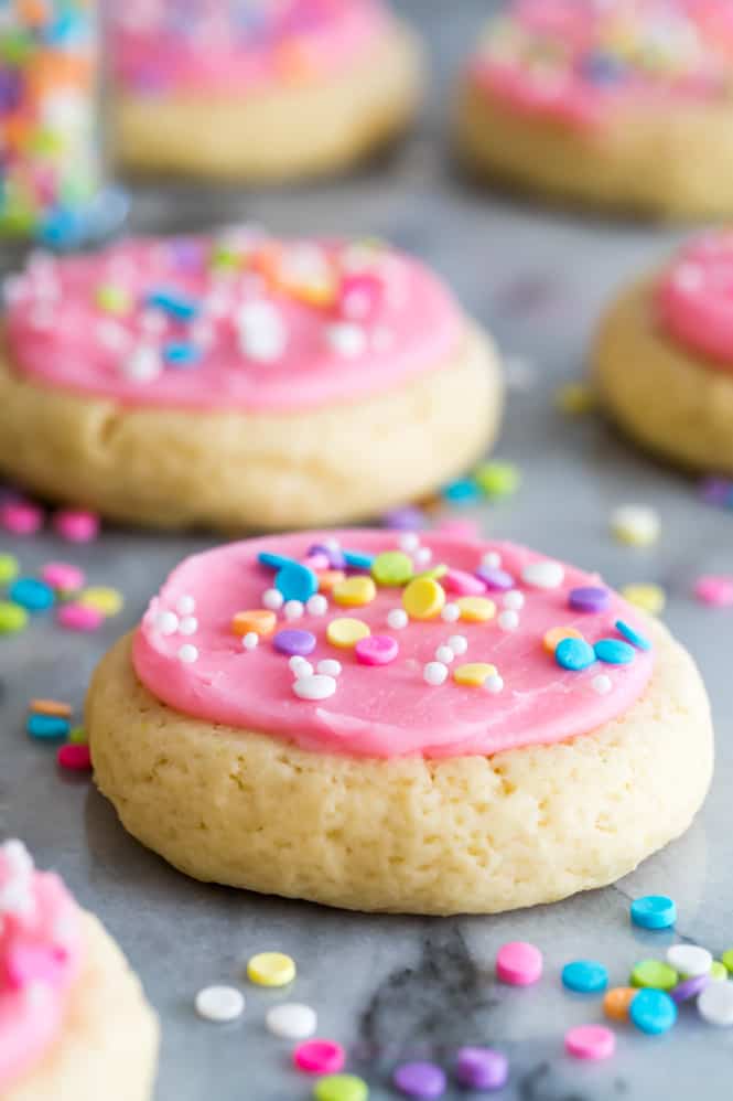 Soft Frosted Sugar Cookies that require no chilling, no rolling pins, and no cookie cutters!  These are similar to the famous “Lofthouse Cookies” and are topped off with a sweet vanilla buttercream frosting and sprinkles.