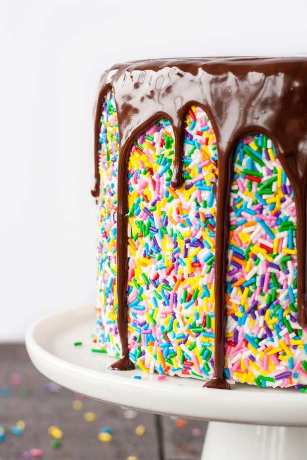 THIS SPRINKLE STUDDED FUNFETTI CAKE IS PAIRED WITH A FLUFFY CREAM CHEESE FROSTING AND TOPPED WITH A RICH DARK CHOCOLATE GANACHE