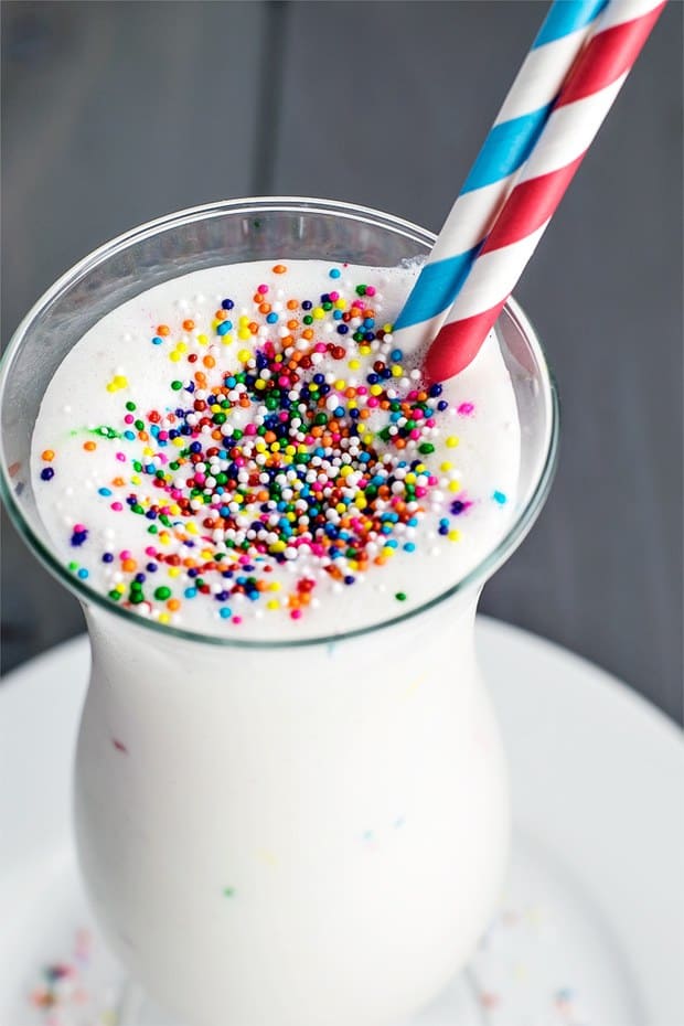 A festive milkshake that's only 4 ingredients: creamy ice cream, rich cake mix, milk, and festive sprinkles.