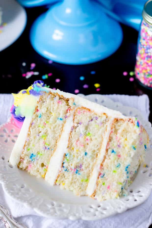 A light and fluffy, made from scratch  funfetti cake (sometimes also called confetti cake)!  This soft, snow-white cake is speckled with brightly colored sprinkles and iced with a sweet buttercream frosting — it’s the perfect homemade birthday cake!