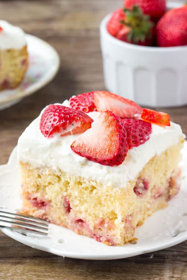 Homemade strawberry cake is super moist, with a delicious vanilla flavor and bursting with fresh berries. Then it’s covered with a sweetened whipped cream topping and even more strawberries.