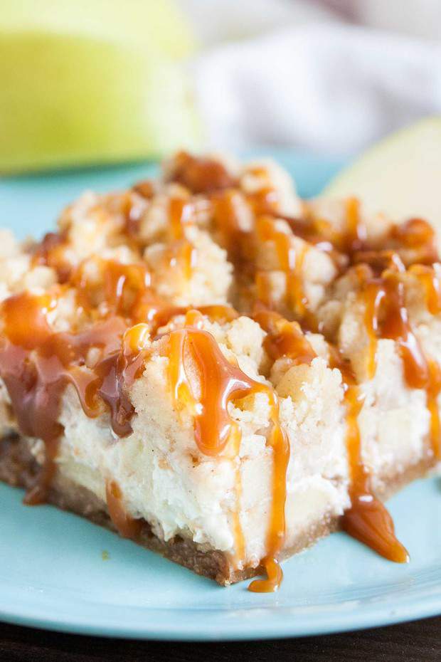 Caramel Apple Cheesecake Bars have three delicious layers and are the perfect fall dessert! A graham cracker crust topped with a creamy cheesecake layer loaded with cinnamon spiced apples and cookie-like streusel and salted caramel on top!