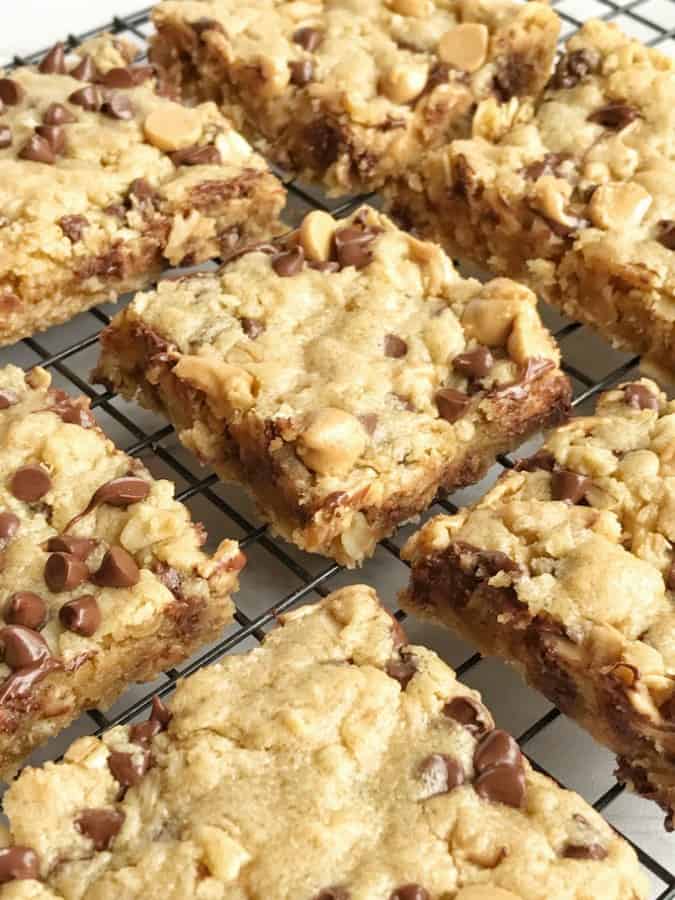 Oatmeal chocolate chip peanut butter bars are a family favorite dessert that everyone loves. Soft cookie bars loaded with oatmeal, peanut butter, peanut butter chips, and chocolate chips. These are a peanut butter & chocolate lovers dream and they come together quickly.