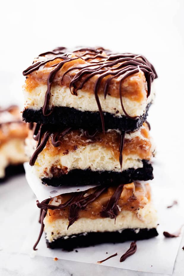 A chocolate oreo crust with creamy cheesecake in the center and topped with coconut caramel and drizzled in chocolate.  All of the things that you love in a Samoa Cookie in a delicious cheesecake dessert!