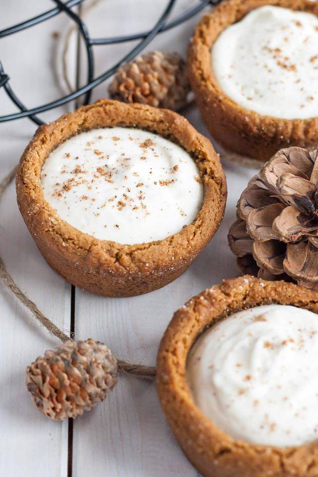 These Eggnog Cheesecake Cookie Cups are the best treat for the holidays! Chewy gingerbread cookie cups filled with a fluffy eggnog cheesecake.