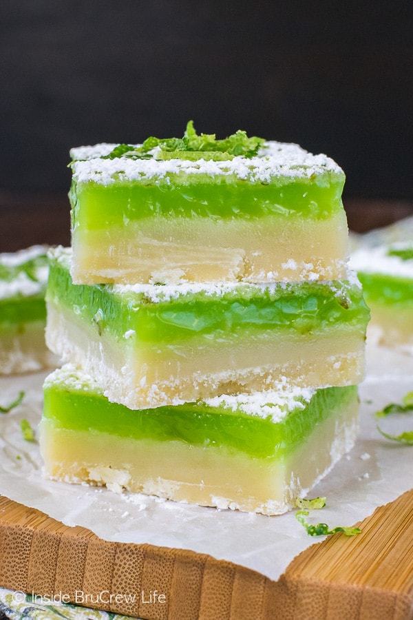 A thick cookie crust and bright green key lime filling make these sweet and tart Key Lime Bars a must make recipe this summer.