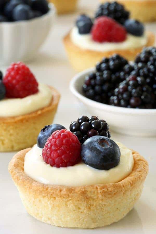 Berry Cookie Cups have a sugar cookie crust and a delicious white chocolate cream cheese filling. Recipe contains a gluten-free option.